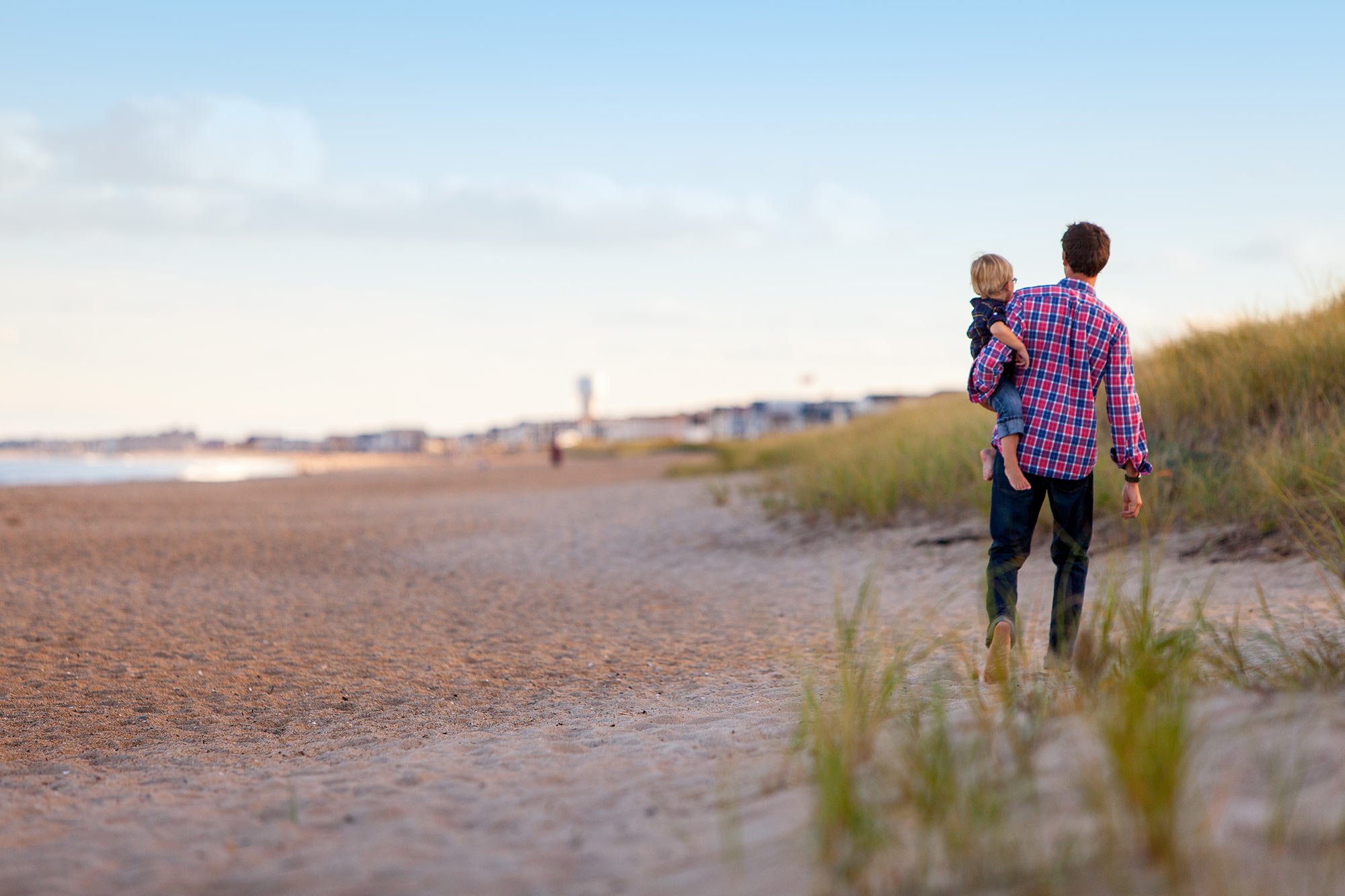 Dad walking with child on the beach